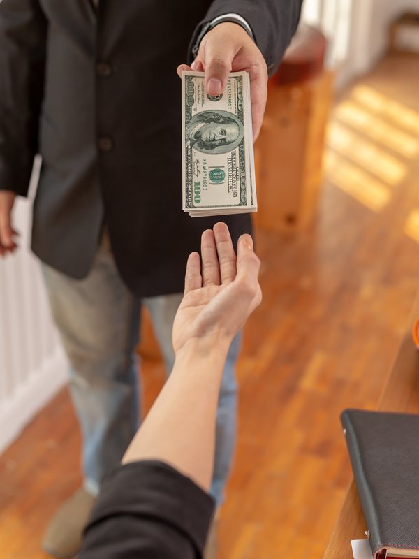 A businessperson paying out cash